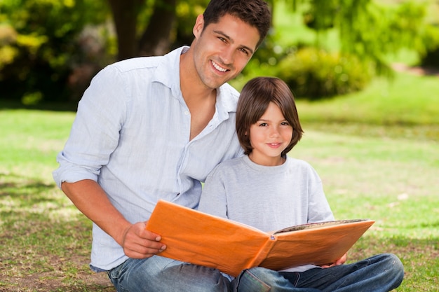 Son with his father looking at their album photo