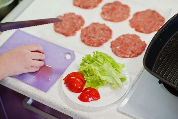 Sooking burgers in the kitchen at home during quarantine time