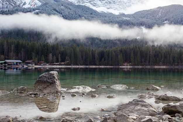 Soothing landscape of a mountain lake Clouds obscure the mountains