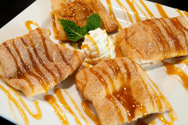 Sopapillas Crisp Cinnamon Pastries Drizzled with Caramel on White Plate