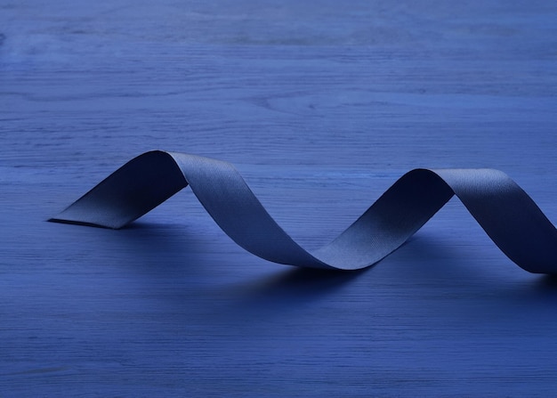 Sophisticated Dark Blue Satin Ribbon on Blue Wooden Background