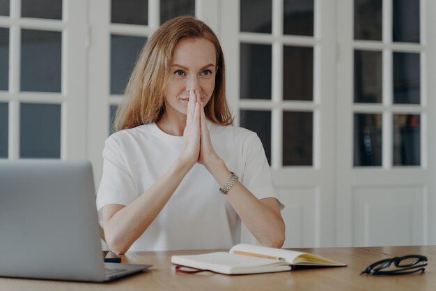 Sophisticated woman sitting with her hands folded and relaxing\
concept of confidence and success