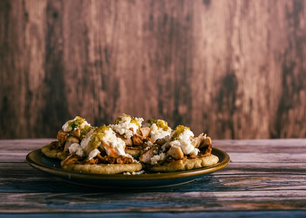 Sopitos typical mexican dish on wooden table Sopes Mexican snack