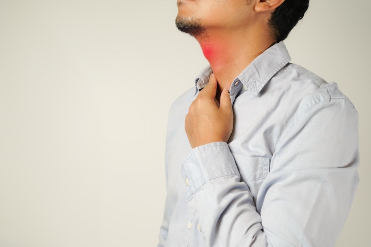 Photo sore throat a man touches a sore neck sore throat in flu season