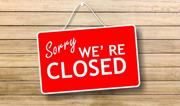 Sorry we are closed sign on wooden background