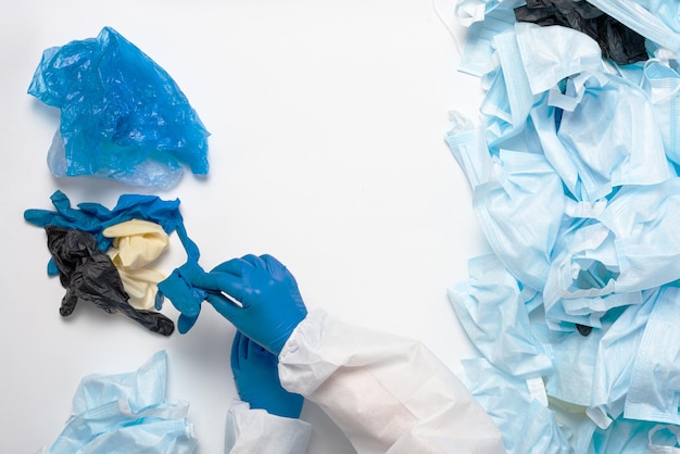 Sorting medical waste after coronavirus. separate collection of\
shoe covers, medical gloves and masks.