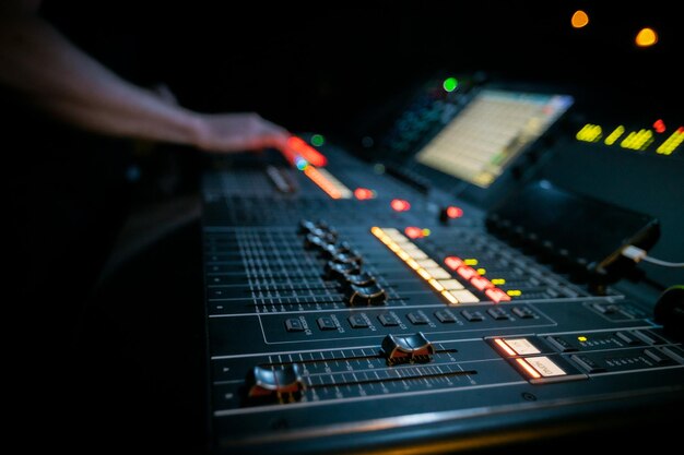 Sound engineer working on a large format digital mixing console