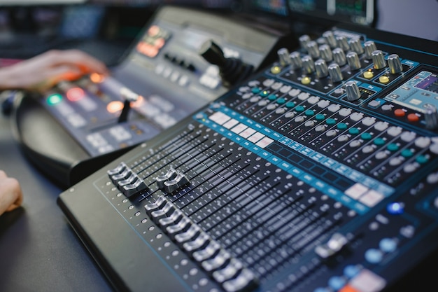 Sound engineer working in studio with equipment