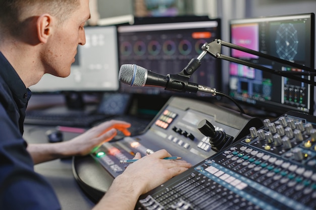 Sound engineer working in studio with equipment