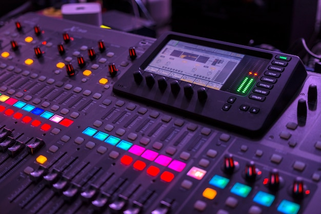 Photo sound engineering running the console during a concert. focus in the central part.