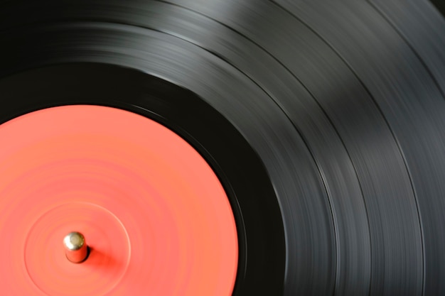 sound tracks on a vinyl black record closeup macro photo
