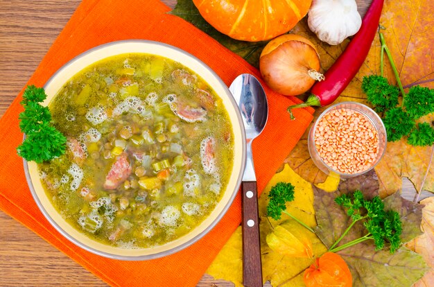 Soup from pumpkin, lentil and sausage. Photo