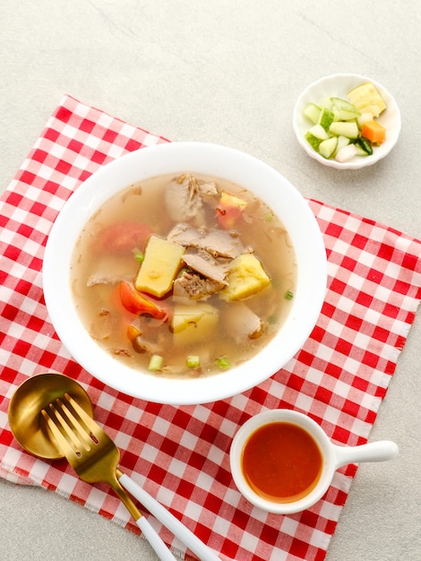 Soup Sop Daging with vegetables is Indonesian traditional food served in bowl Selected focus
