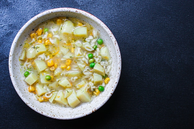 Soup vegetables and pasta alphabet, peas, corn