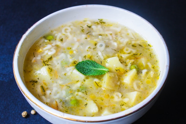 Soup vegetables and pasta alphabet, peas, corn