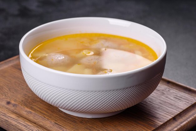 Soup with turkey meatballs potatoes and vegetables Selective focus