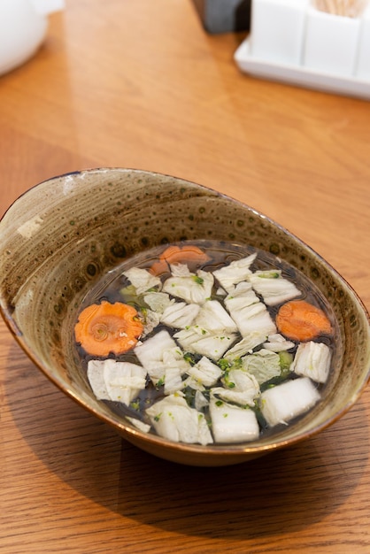 Soup with vegetables and shiitake mushrooms in a bowl Asian cuisine vegetarian food