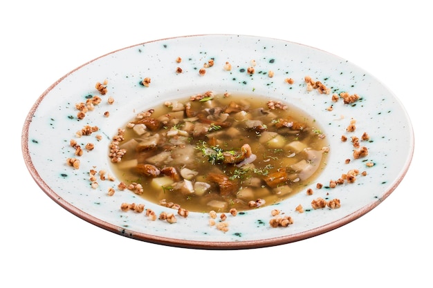 Soup with white mushrooms and buckwheat Vegetarian dish On white background