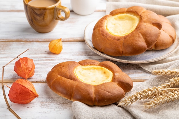 Sour cream bun with cup of coffee