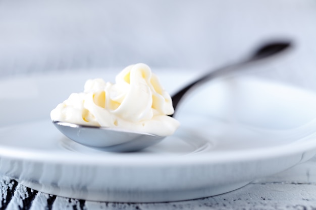 Sour cream in spoon