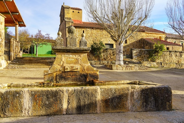 Source of fresh mountain water in the square of the old stone village Spain