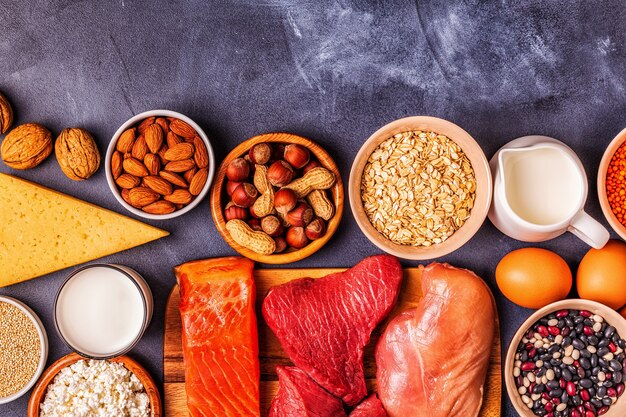 Photo sources of healthy protein - meat, fish, dairy products, nuts, legumes, and grains.