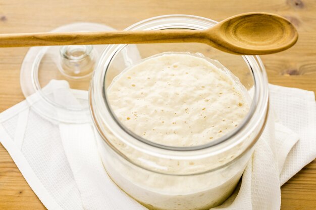 sourdough starter in large glass jar on the table.