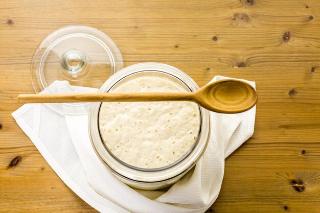 Sourdough starter in large glass jar on the table