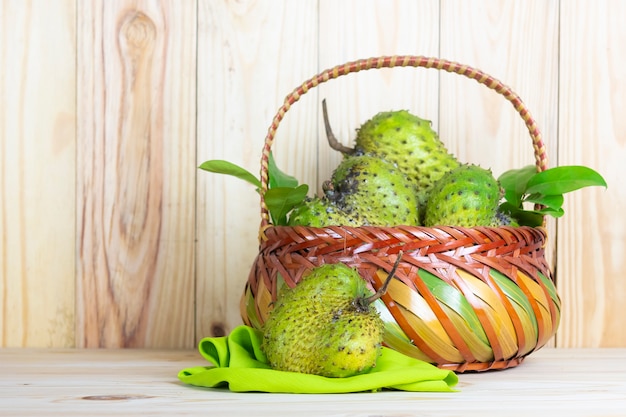 Soursop fruit on wooden table.