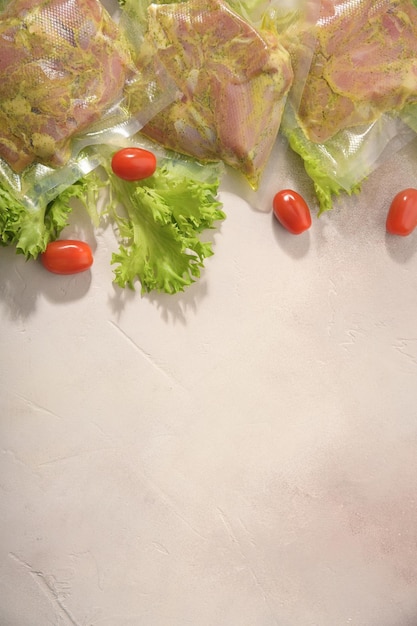 Sous Vide cooking concept Vacuum packed ingredients arranged on light background