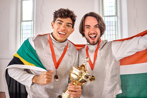 South Africa flag fencing and men with trophy for winning competition challenge and sports match Winner sword fighting and portrait of male athletes celebrate with prize for games or tournament