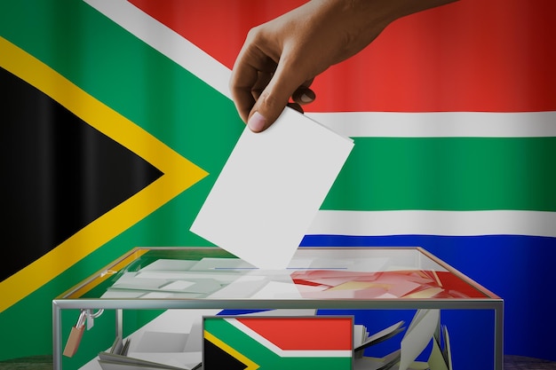 South africa flag hand dropping ballot card into a box voting election concept