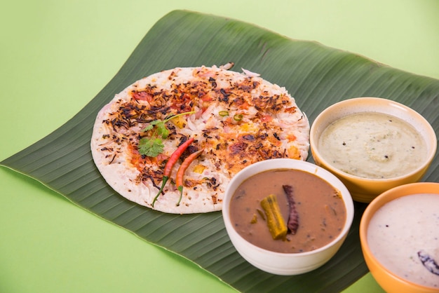 South indian food uttapam or ooththappam or uthappa is a dosa-like dish made by cooking ingredients in a batter, served with coconut chutney, green chutney and sambar