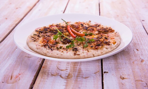 Il cibo dell'india meridionale uttapam o ooththappam o uthappa è un piatto simile alla dosa preparato cuocendo gli ingredienti in una pastella, servito con chutney di cocco, chutney verde e sambar