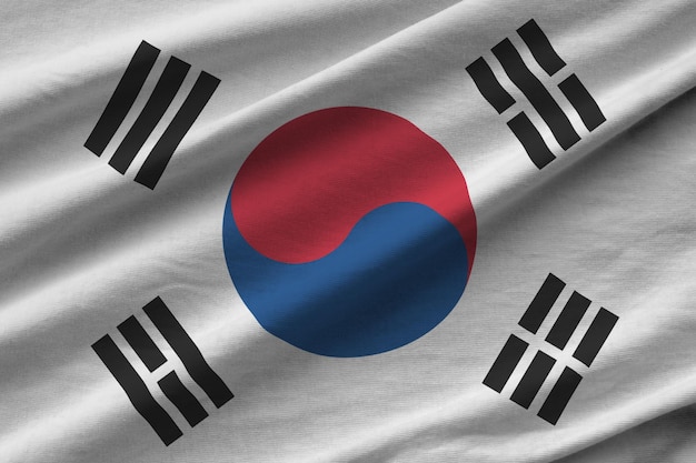 South Korea flag with big folds waving close up under the studio light indoors The official symbols and colors in banner