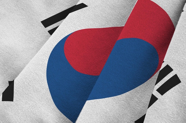 Photo south korea flag with big folds waving close up under the studio light indoors the official symbols and colors in banner