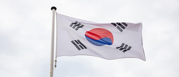 South Korean flag waving against cloudy sky