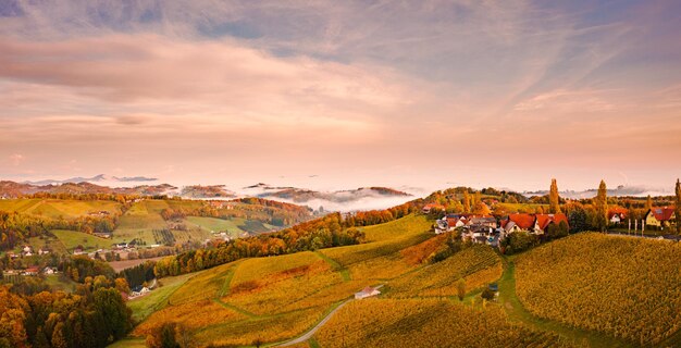 South styria vineyards landscape aerial view from eckberg at autumn grape hills and foggy alps