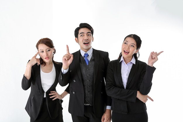 southeast asian young office business man woman wearing suit point finger showing up expressions idea thinking wonder wow on white studio background