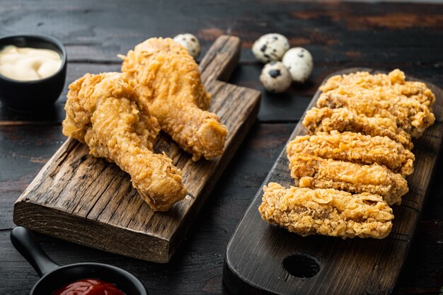 Southern fried chicken cuts on dark wooden background