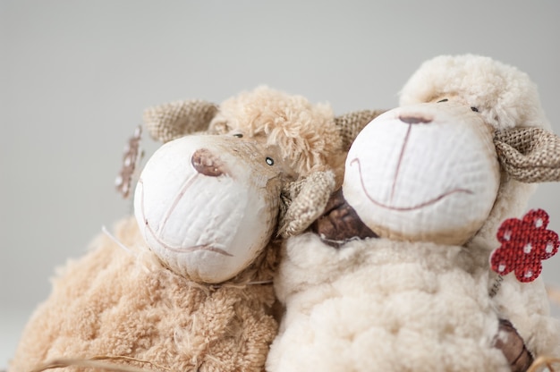 Photo souvenir toy lamb of textile close-up on a gray background