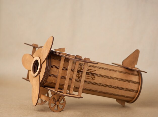 Souvenir toy wooden plane on brown background