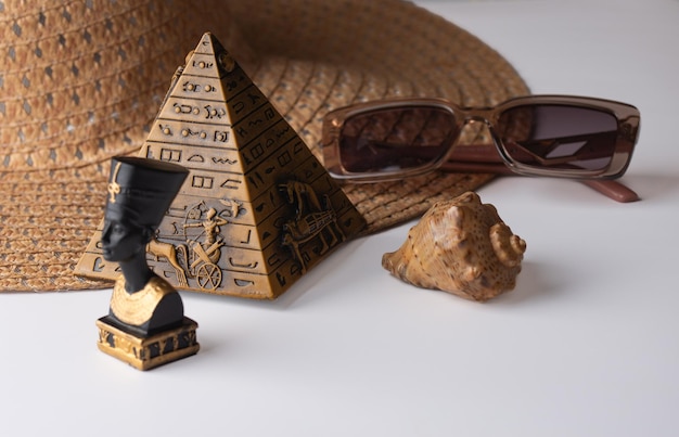 souvenirs shellpyramid and glasses on the hat white background