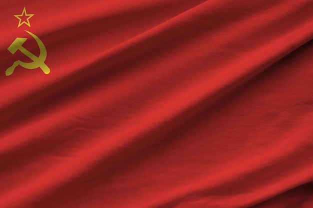 Soviet Union flag with big folds waving close up under the studio light indoors The official symbols and colors in banner