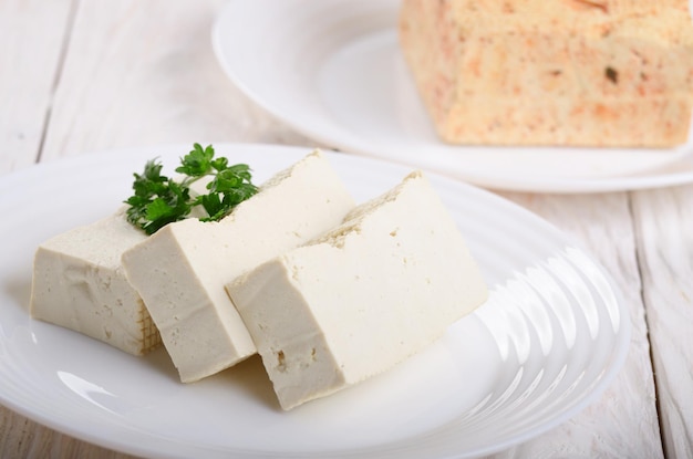 Soy Bean curd tofu on clay dish closeup Nondairy alternative substitute for cheese