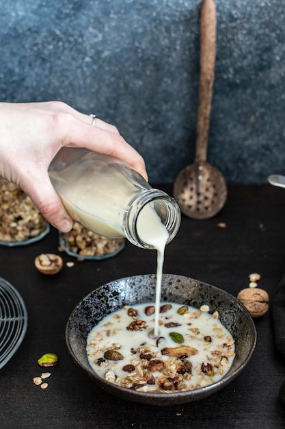 Soy milk being poured on granola