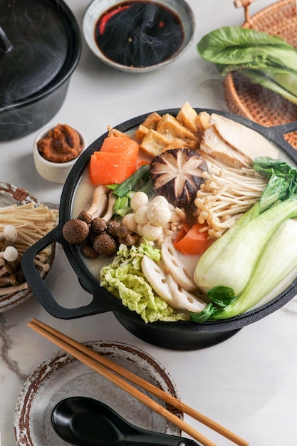 Soy Milk Hot Pot recipe with napa cabbage mushrooms and thinly sliced pork cooked in a creamy and savory soy milk broth