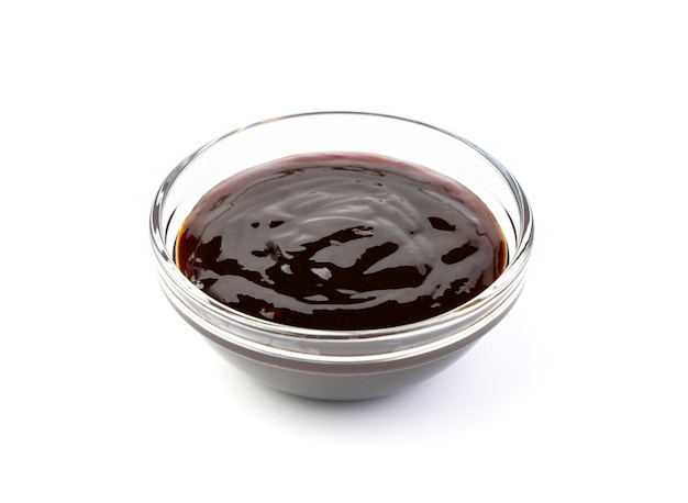 Soy sauce in a transparent cup on a white background