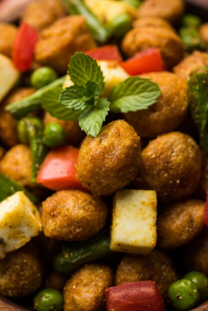 Soya chunks masala fry or meal maker fry using paneer or\
cottage cheese cubes and vegetables. popular healthy snack recipe\
from india. served in a bowl. selective focus