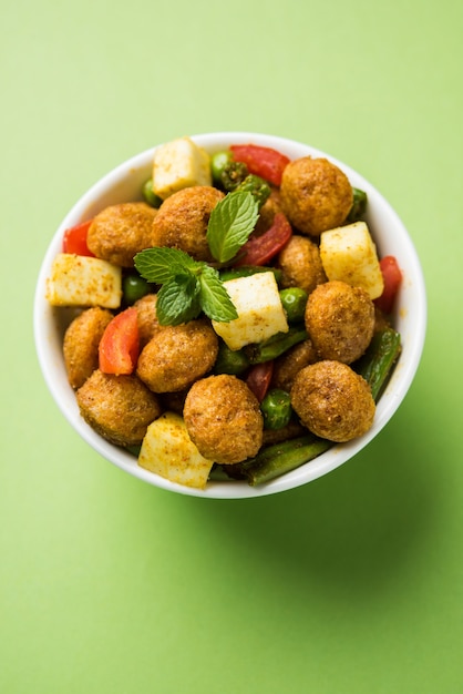 Soya chunks masala fry or meal maker fry using paneer or\
cottage cheese cubes and vegetables. popular healthy snack recipe\
from india. served in a bowl. selective focus